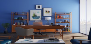 Home staging art hangs against a blue wall in an office with a desk and bookshelves