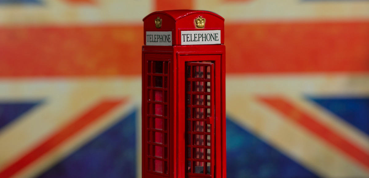 Telephone booth against a UK flag