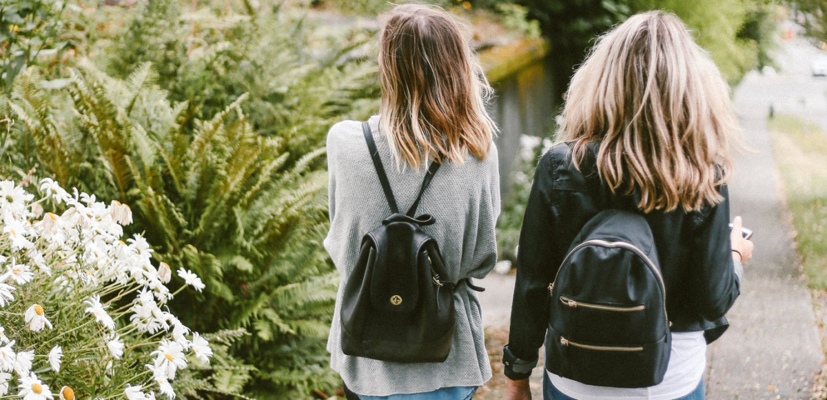 Two student women walking together