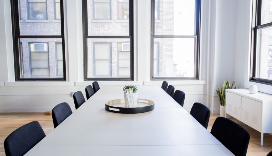 White conference table with black chairs in a downtown office
