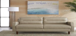 A mid-century modern style couch with a painting above it