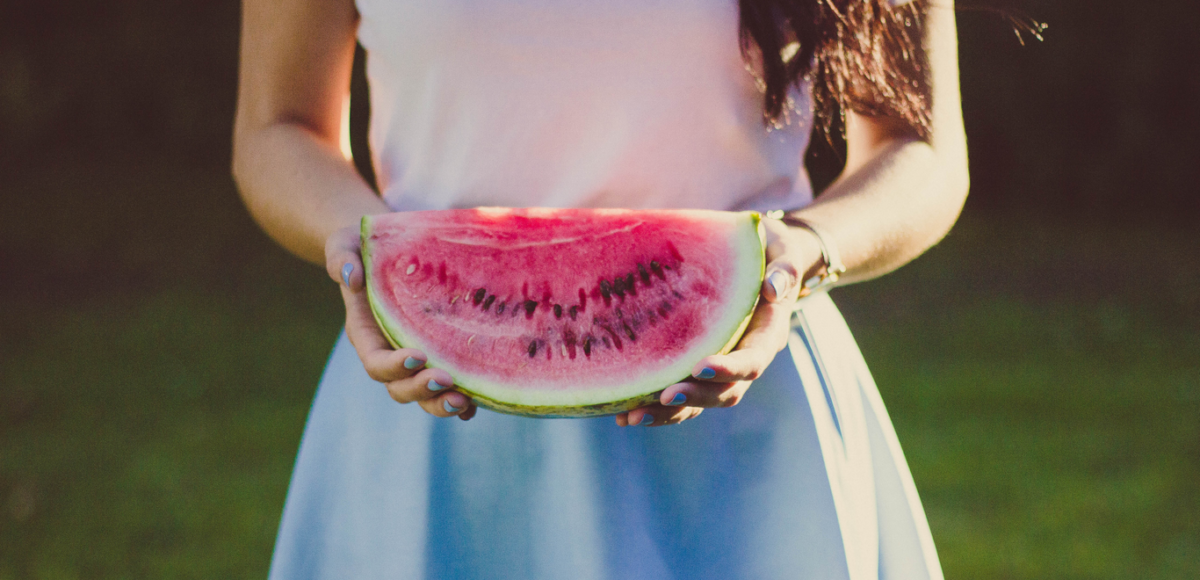 Woman in White and Blue Dress Holding Water Melon