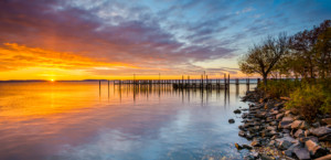 Sunrise over Chesapeake Bay with dock extending from shoreline