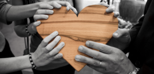 Women holding wooden heart