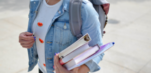 Student walking on campus with books