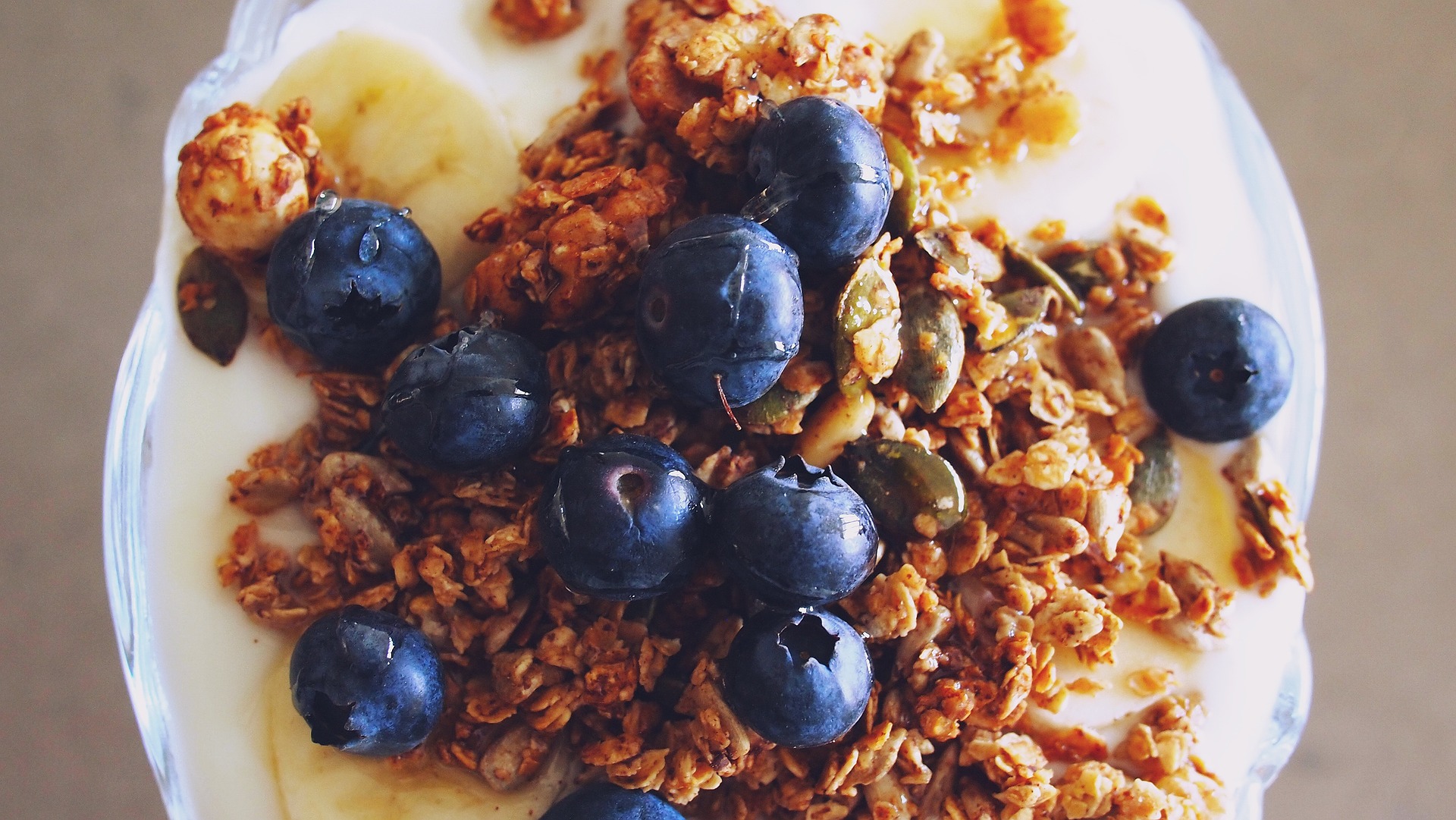 A healthy breakfast of fruit, granola, and yogurt