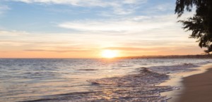 Sun setting over a peaceful beach scene