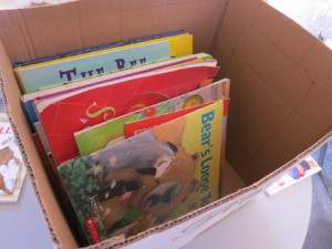 A cardboard box filled with children's books