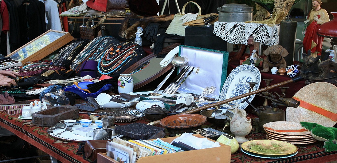 Yard sale table with an assortment of items 