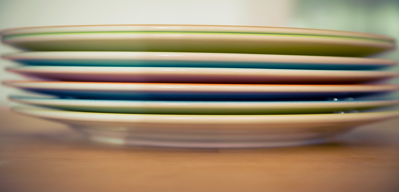 Close-up of a stack of ceramic dinner plates ready for  packing
