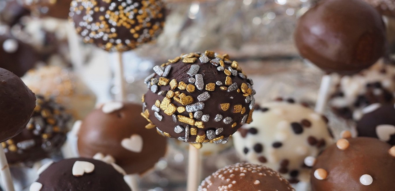 Assorted cake pops decorated with icing and sprinkles