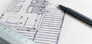 Close-up of a floor plan, drafting pencil, and ruler