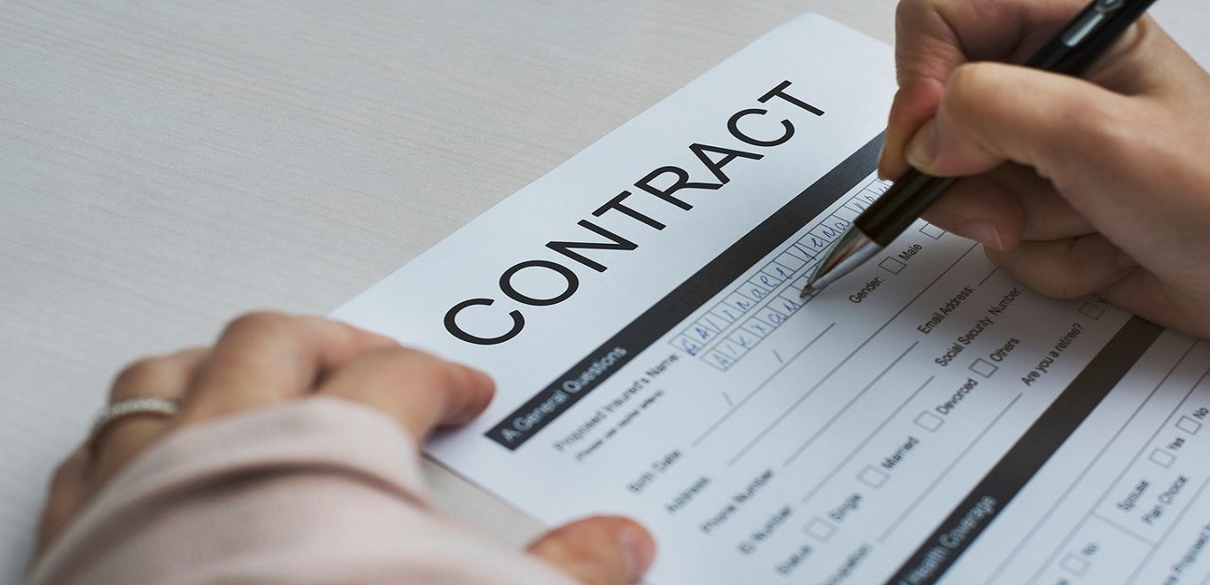 Person filling out a contract