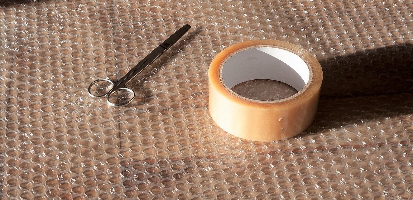 Bubble wrap, packing tape, and scissors