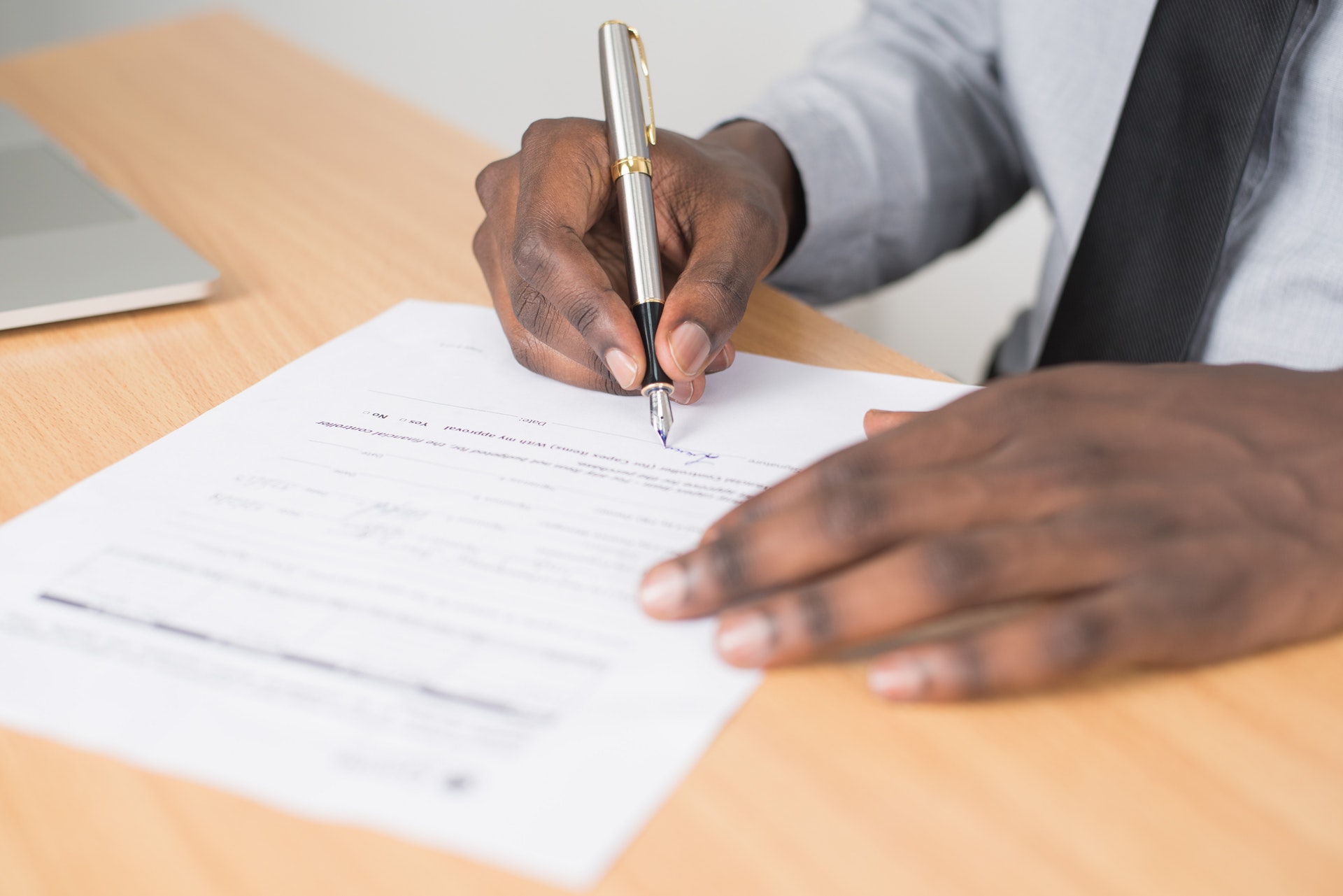 Close-up of male hands signing a rental lease
