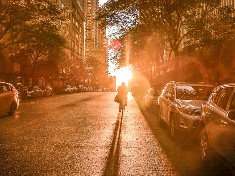 Person in a city street, warm sunlight, the glow of moving to a new city alone