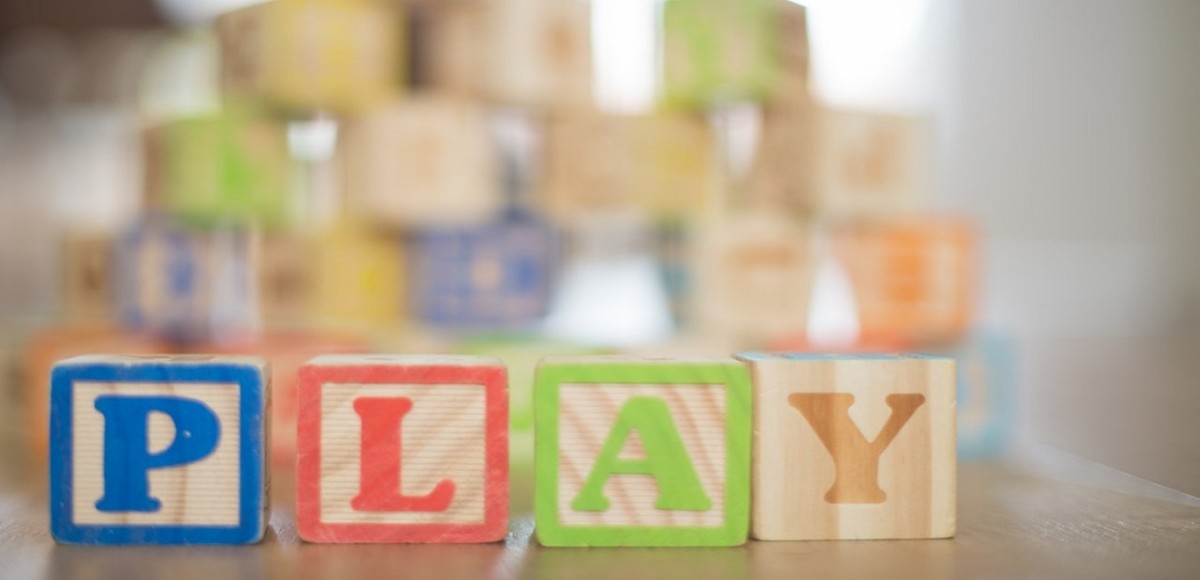 Wooden children's blocks spelling out the word "play"
