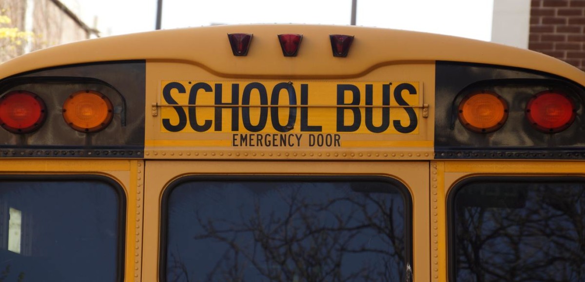 Up-close shot of the back of a yellow school bus