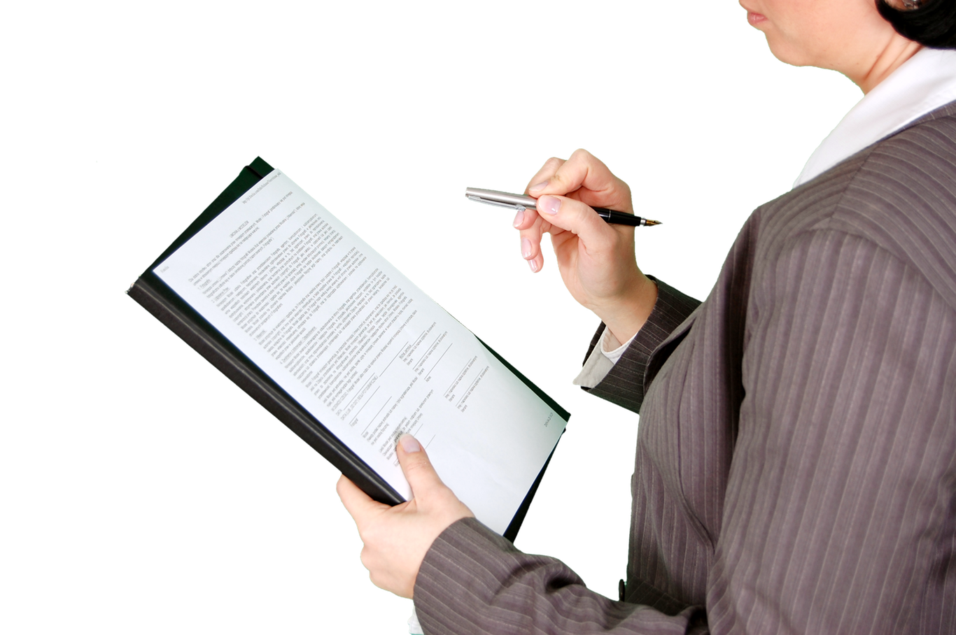 Woman in a suit with pen in hand reads a furniture financing contract