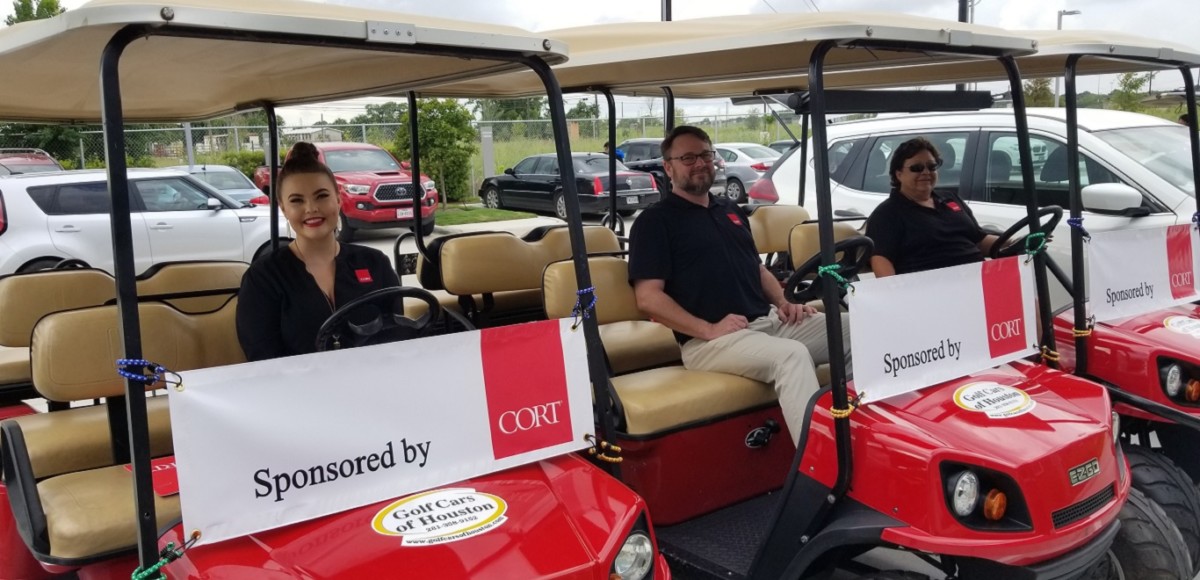 CORT employees in golf carts.