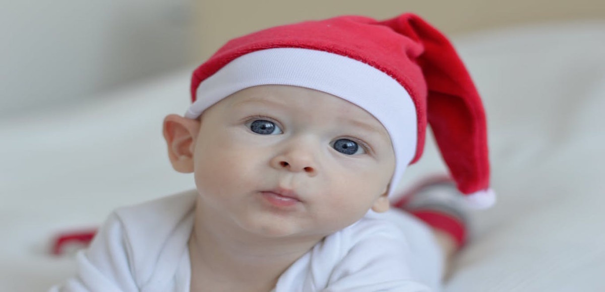 Smiling baby wearing a Santa hat