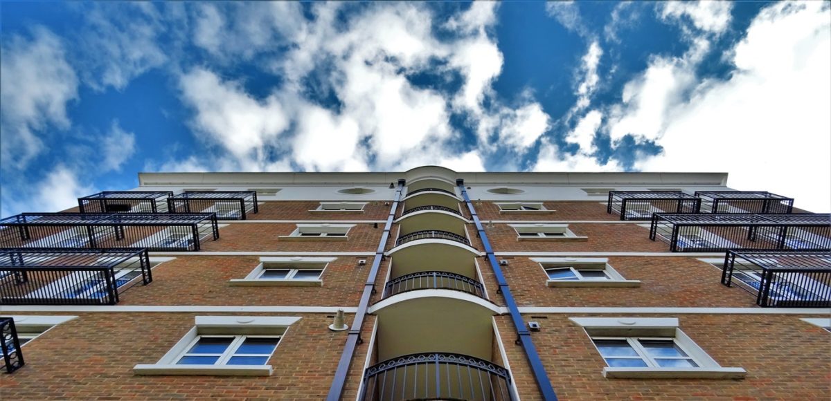 Brown multi-level apartment building with blue sky