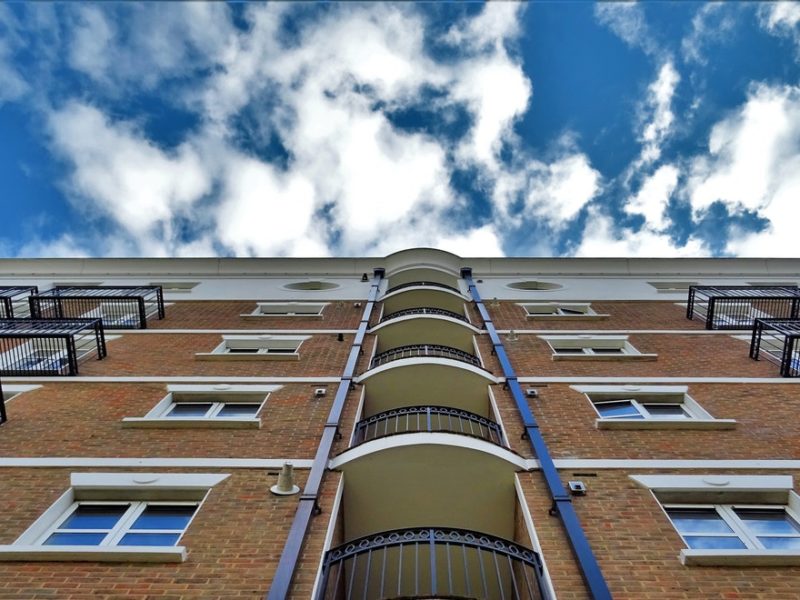 Brown multi-level apartment building with blue sky
