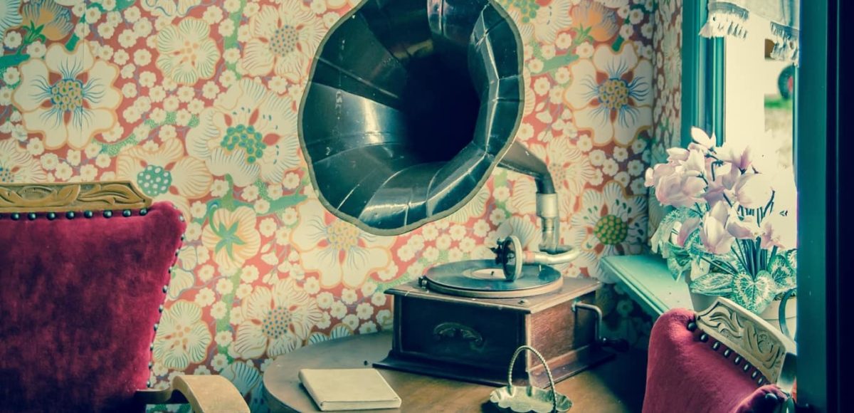 Vintage gramaphone against floral wallpaper