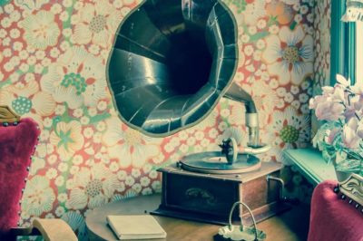 Vintage gramaphone against floral wallpaper