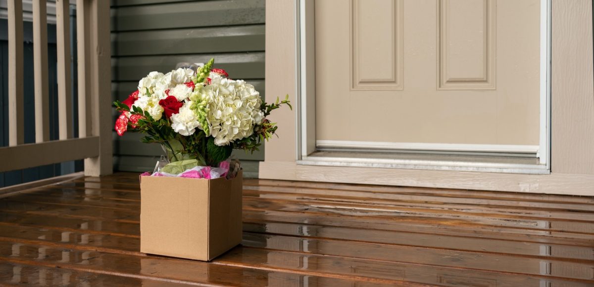 Box of flowers delivered to a doorstep