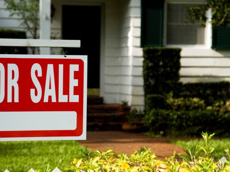 For Sale sign in front of home
