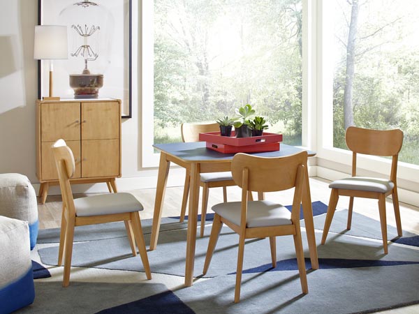 Light colored modern nordic inspired furniture, table and chairs in front of window.