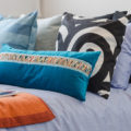 Cluttercore aesthetic pillows and blankets mixed patterns