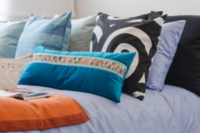 Cluttercore aesthetic pillows and blankets mixed patterns