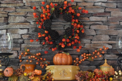 fall aesthetic at home with pumpkins, wreath, and natural elements to create mantle display