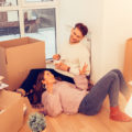 Couple moving into home unpacking and relaxing after moving during the holidays