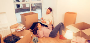 Couple moving into home unpacking and relaxing after moving during the holidays