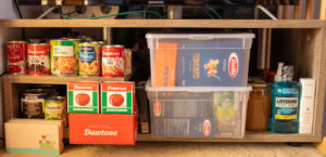 Apartment prepper disaster relief kit in case of emergency containing non-perishable food and first-aid items.