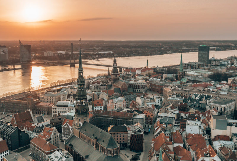 RIga rooftop view panorama at sunset with urban architectures and Daugava River. View of the old town