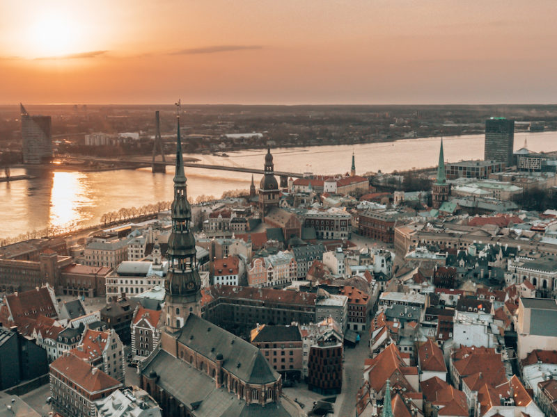 RIga rooftop view panorama at sunset with urban architectures and Daugava River. View of the old town