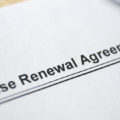 Legal document Lease Renewal Agreement on paper close up created after learning how to negotiate lease.