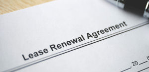 Legal document Lease Renewal Agreement on paper close up created after learning how to negotiate lease.