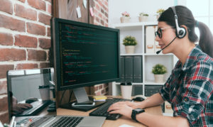 Woman working from desk at home.