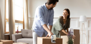 A happy couple packing moving boxes together.
