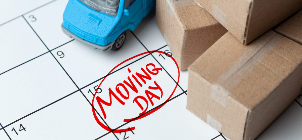 A calendar with "moving day" circled in red.