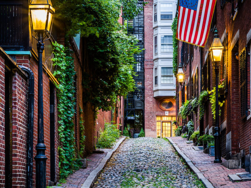Cobblestone street lined with old brick buildings in Boston, Massachusetts.