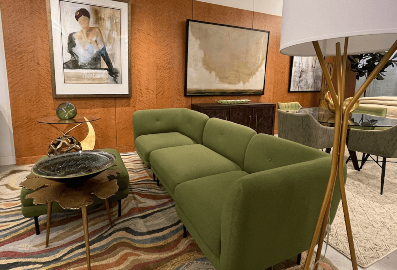 A stylish living room set up featuring a dark green sofa.