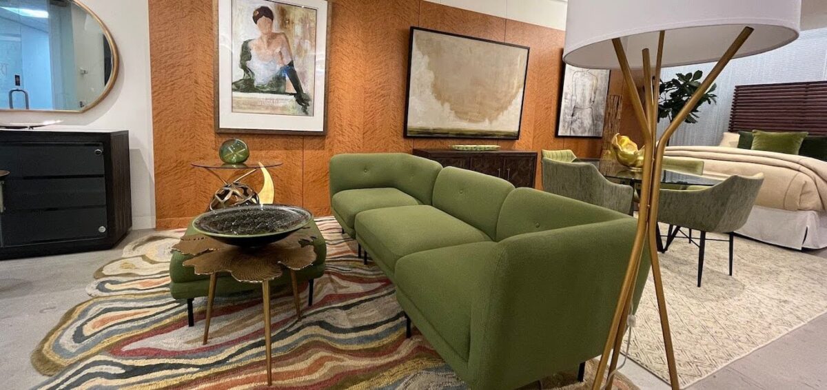 A light green sofa paired with art and decor featuring pops of green.