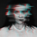 A surreal, glitchy, black-and-white photo of a woman.