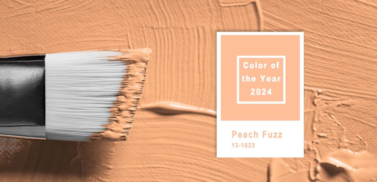 A paintbrush with Pantone's Color of the Year, Peach Fuzz.